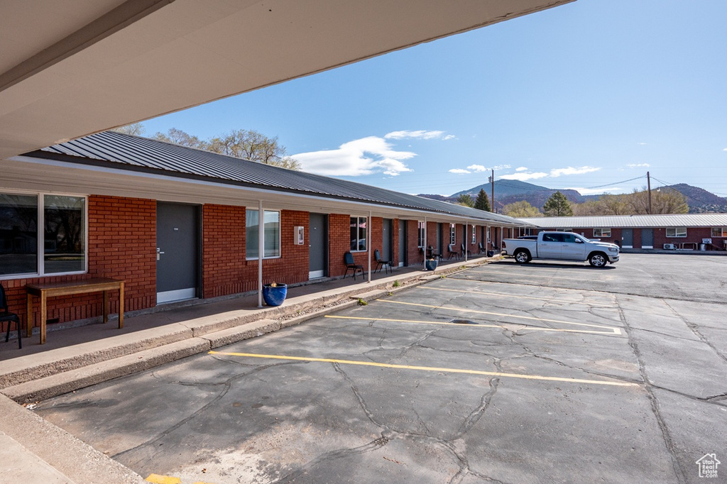 Uncovered parking lot featuring a mountain view