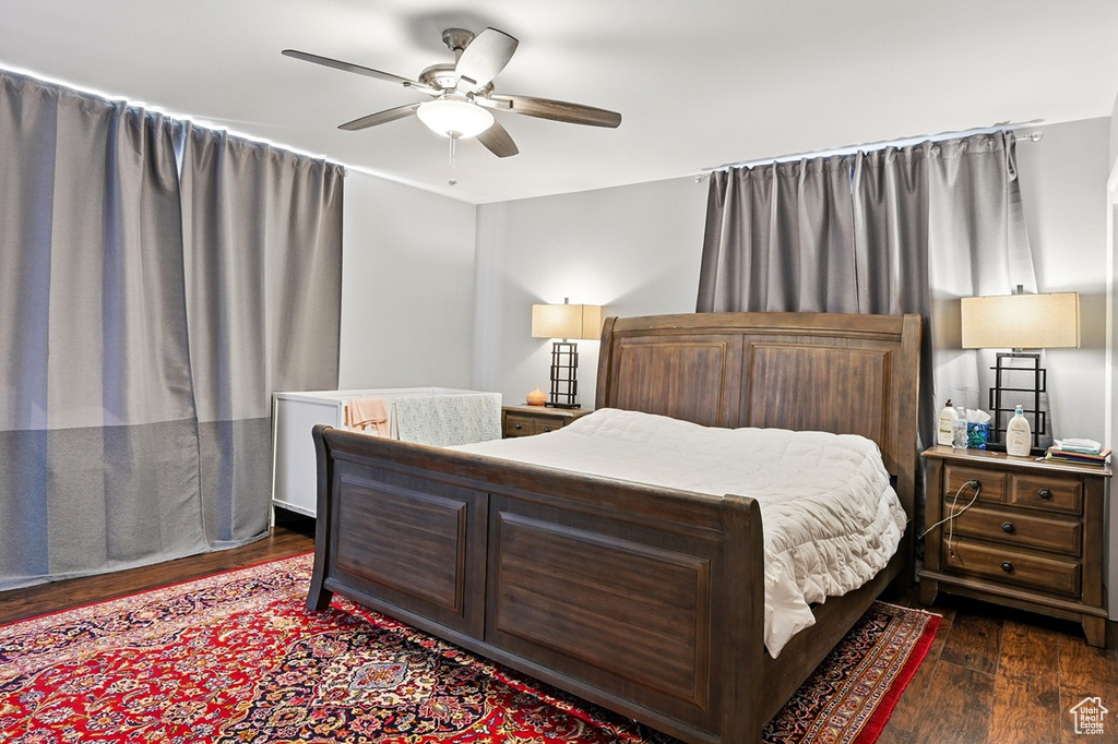 Bedroom with a ceiling fan and dark wood-style flooring