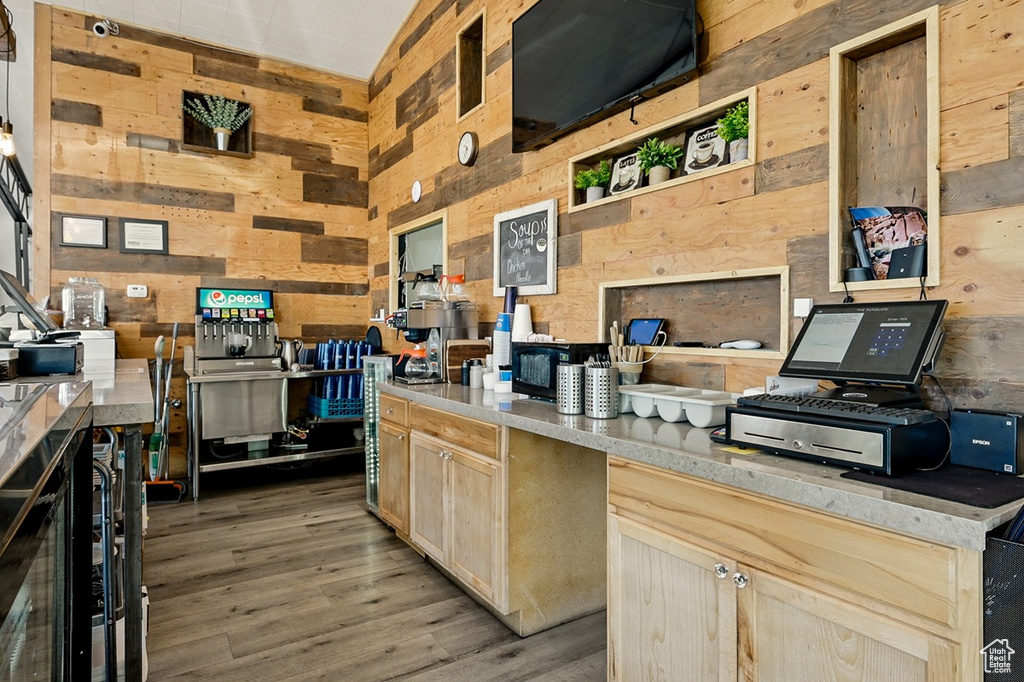 Kitchen with wood walls, open shelves, and light wood-type flooring