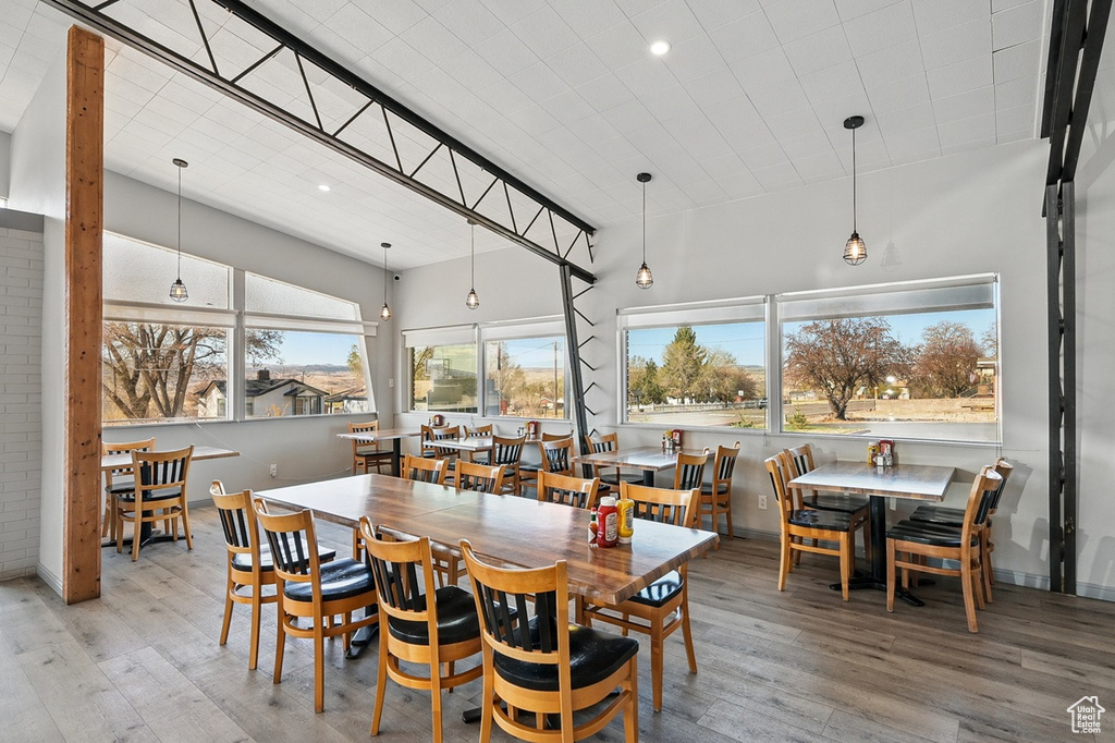 Dining area with baseboards, wood finished floors, and recessed lighting