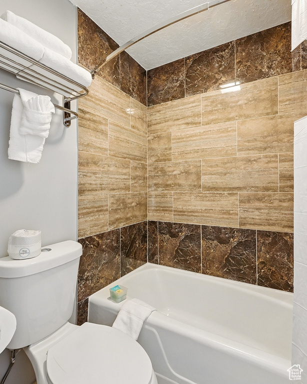 Full bathroom featuring toilet and shower / tub combination
