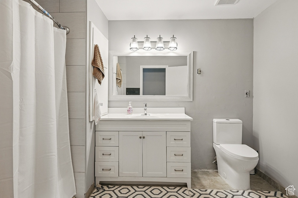Full bathroom featuring visible vents, vanity, and toilet
