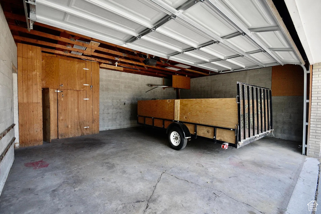 Garage featuring concrete block wall