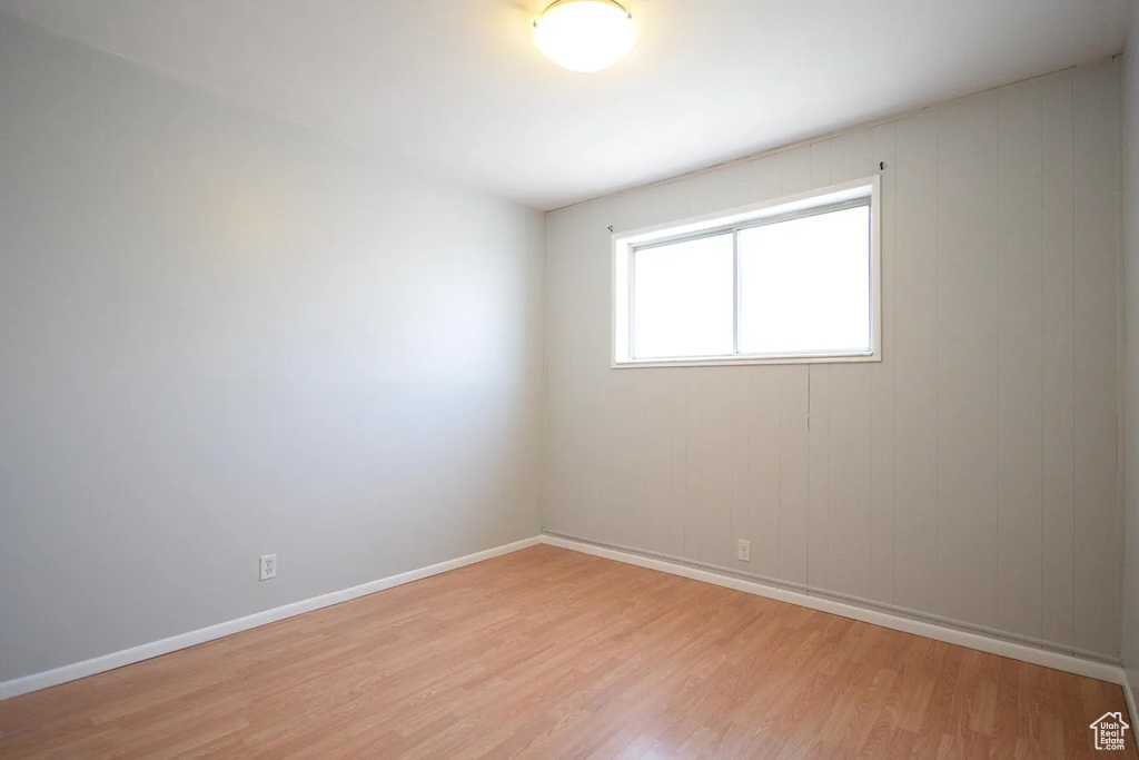 Spare room with light wood-style flooring and baseboards