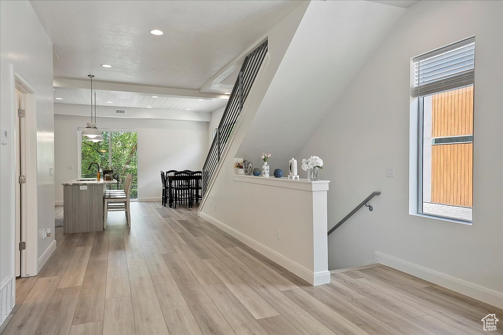 Corridor with baseboards, recessed lighting, an upstairs landing, and light wood finished floors