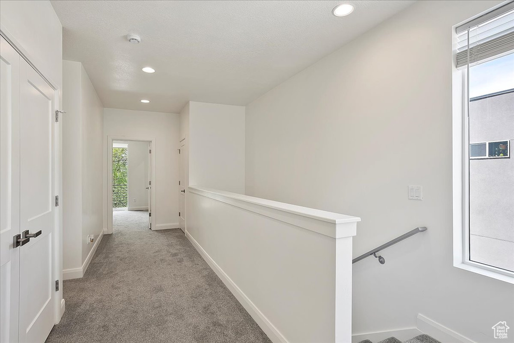 Corridor featuring baseboards, recessed lighting, an upstairs landing, and carpet floors