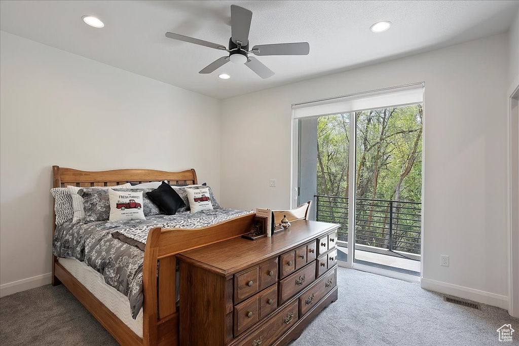 Bedroom with light colored carpet, access to exterior, and multiple windows