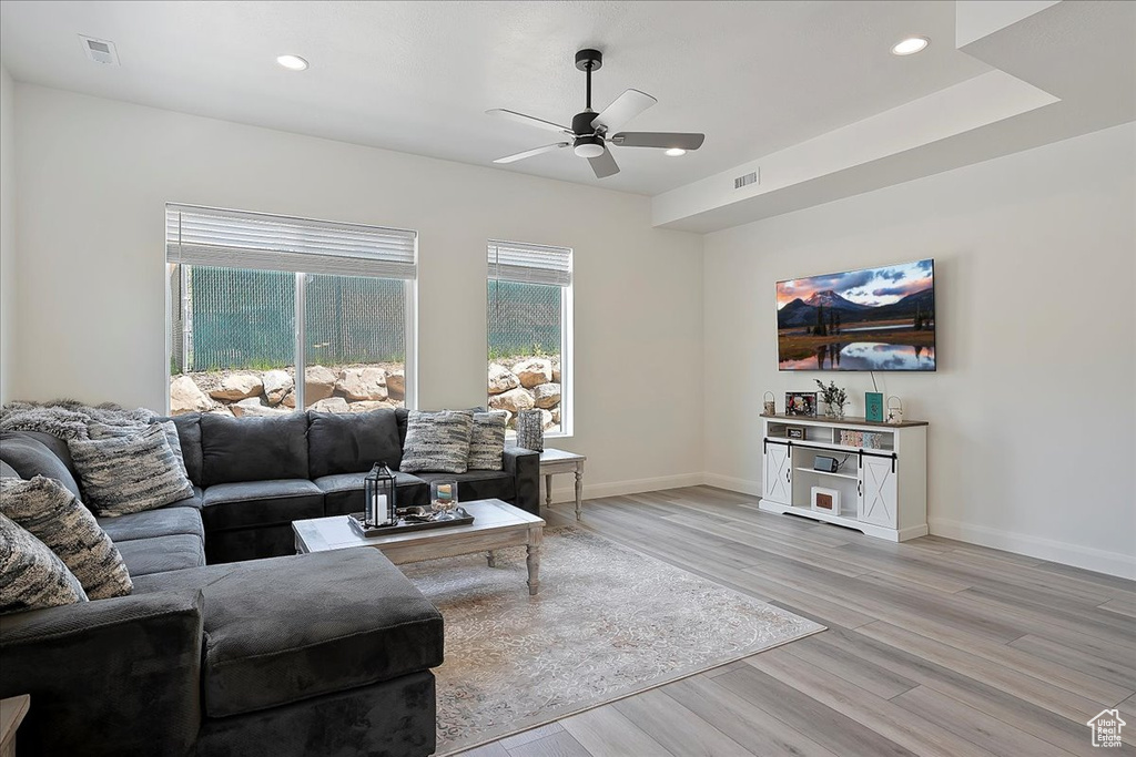 Living room featuring recessed lighting, a ceiling fan, visible vents, and light wood-type flooring