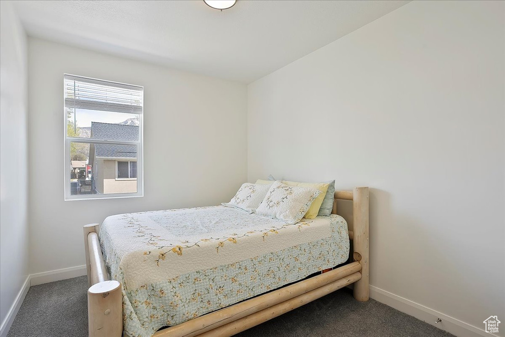 Bedroom with carpet flooring and baseboards