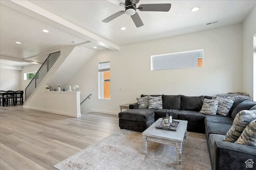 Living room with recessed lighting, light wood finished floors, and visible vents