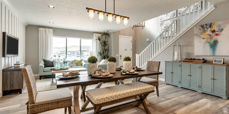 Dining room featuring recessed lighting, stairs, light wood-style flooring, and baseboards