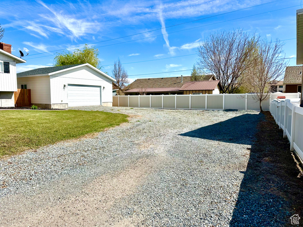 View of yard with an outbuilding, a garage, and a fenced backyard