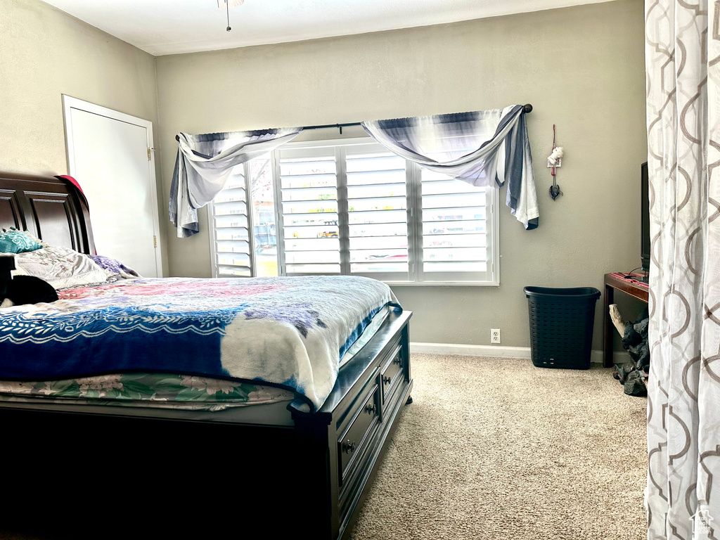 Bedroom featuring carpet flooring and baseboards