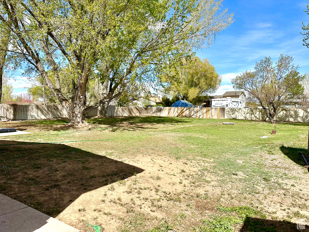 View of yard featuring fence