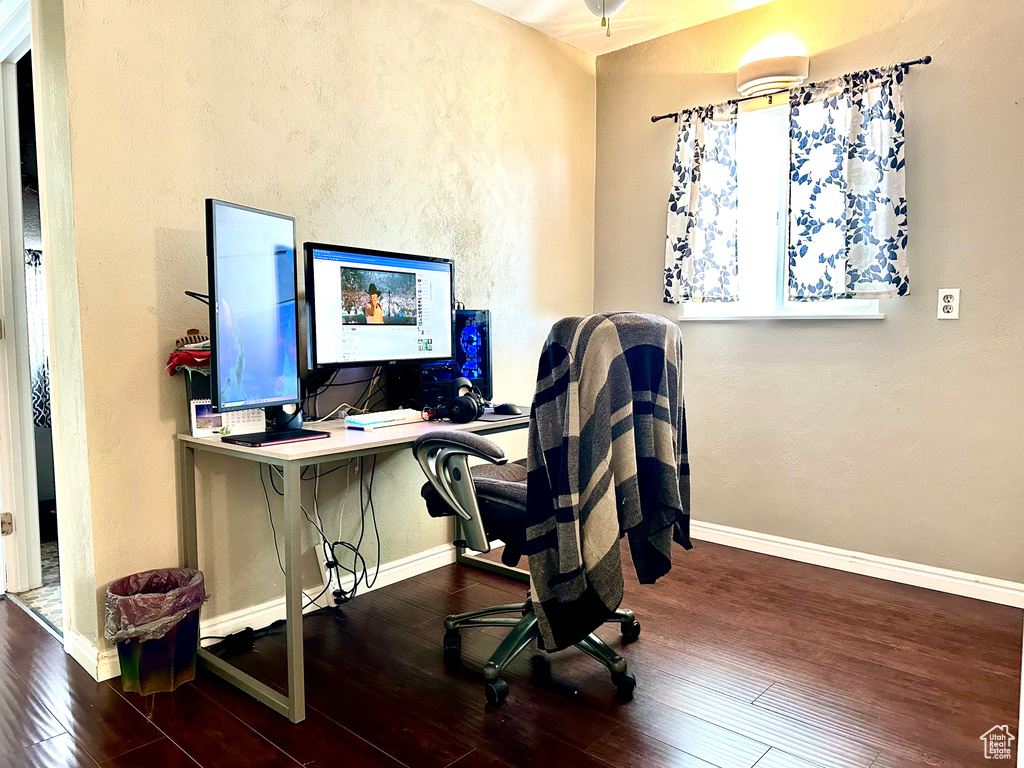 Office featuring a textured wall, hardwood / wood-style flooring, and baseboards
