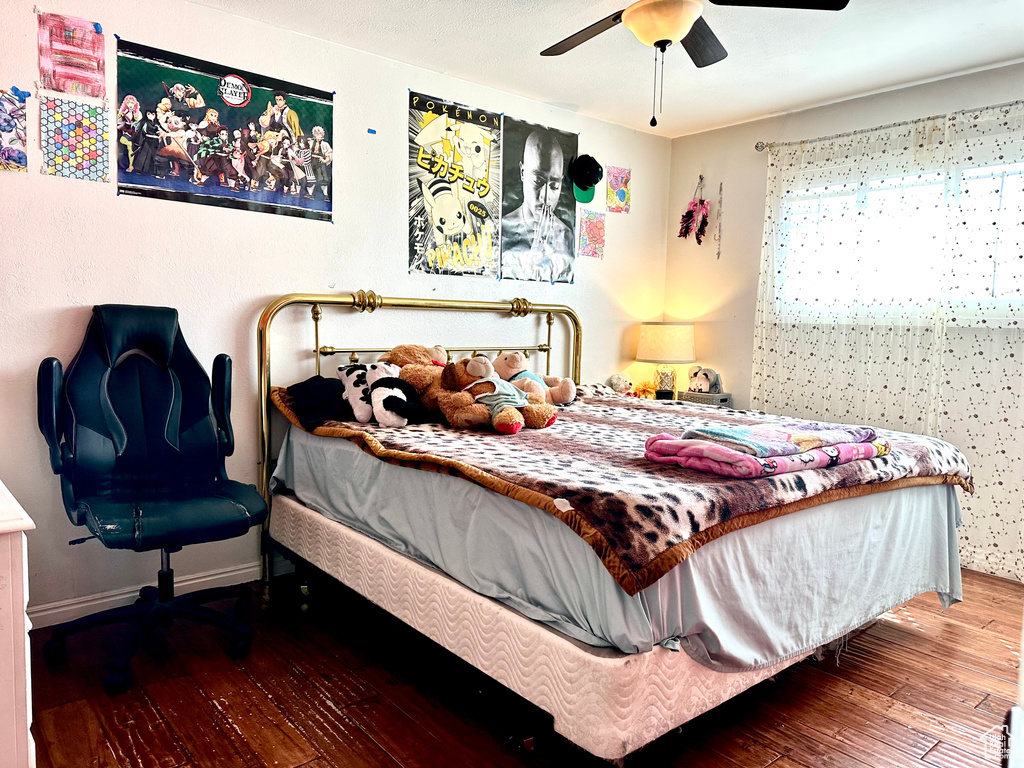 Bedroom featuring hardwood / wood-style flooring and a ceiling fan