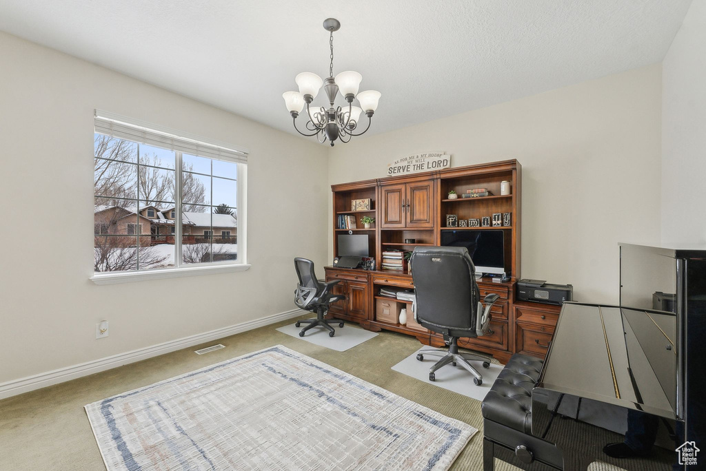 Home office featuring light colored carpet, a notable chandelier, visible vents, and baseboards
