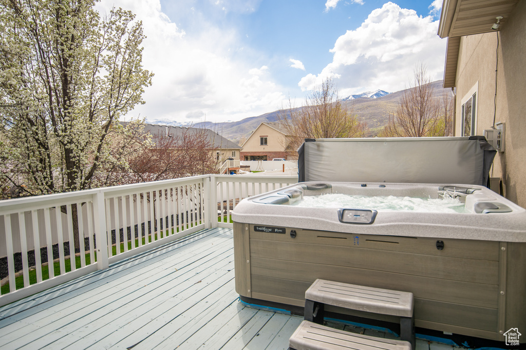 Deck with a mountain view and a hot tub