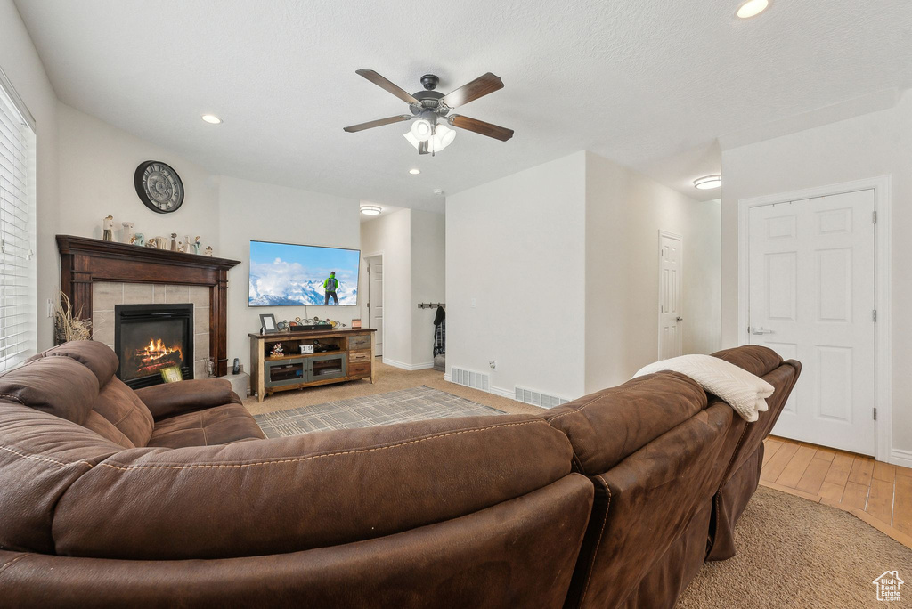 Living room featuring a fireplace, visible vents, and recessed lighting