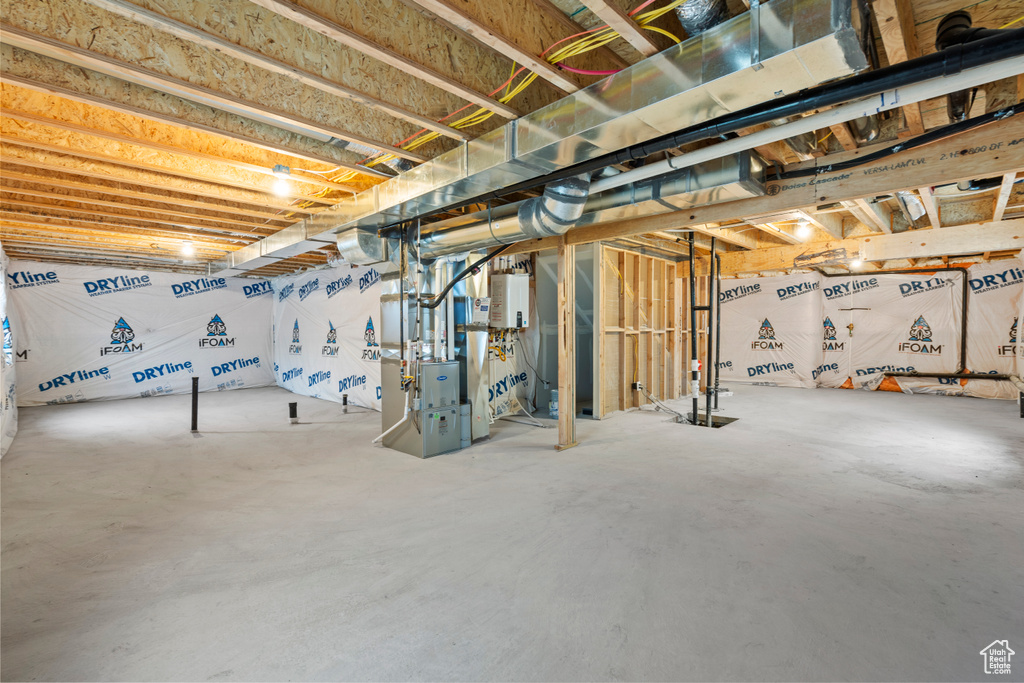 Unfinished below grade area featuring heating unit