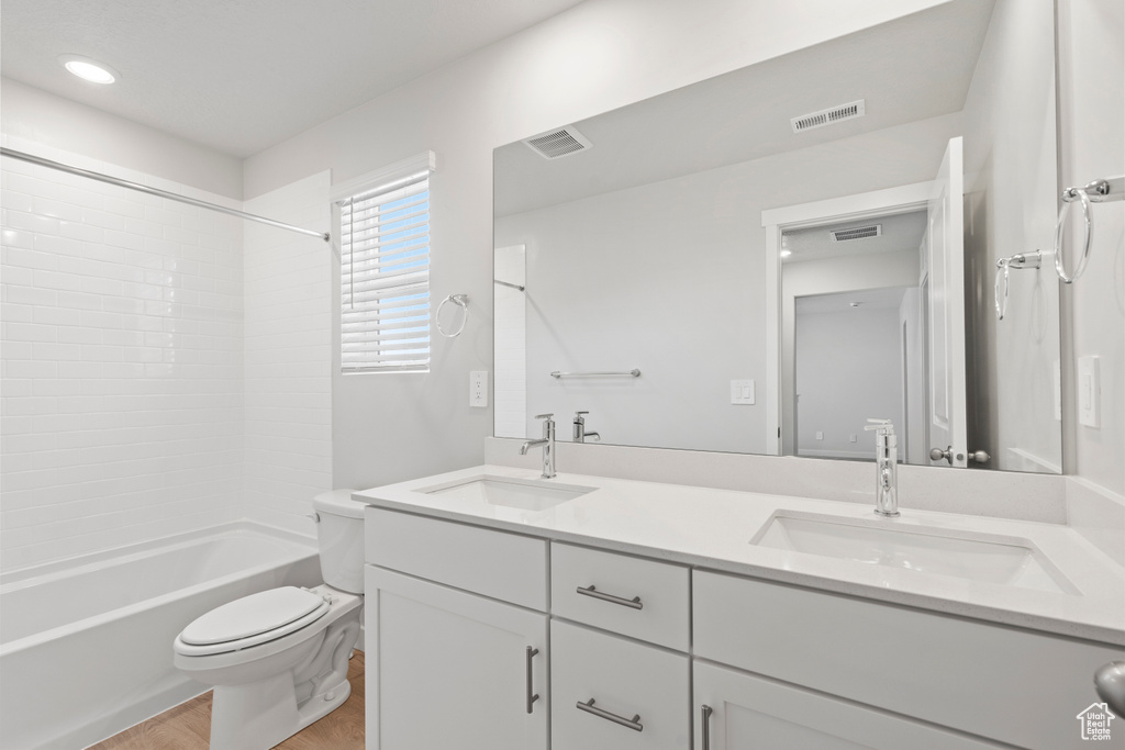 Bathroom with a sink, toilet, and visible vents