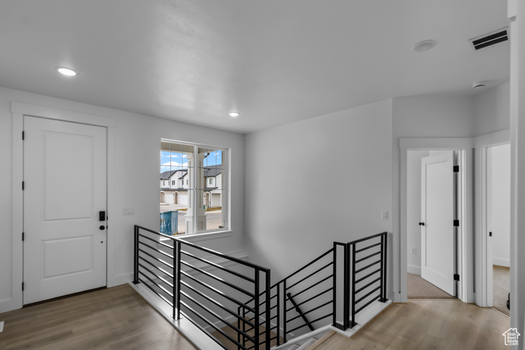 Foyer entrance featuring wood finished floors, visible vents, and recessed lighting