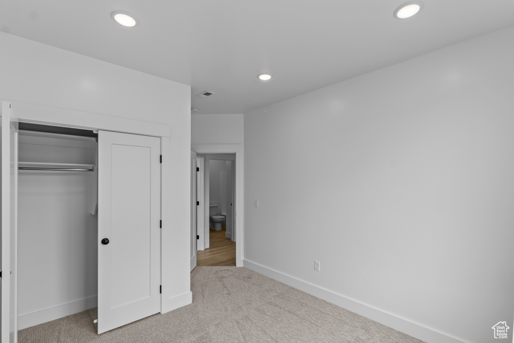 Unfurnished bedroom with baseboards, recessed lighting, a closet, and carpet flooring