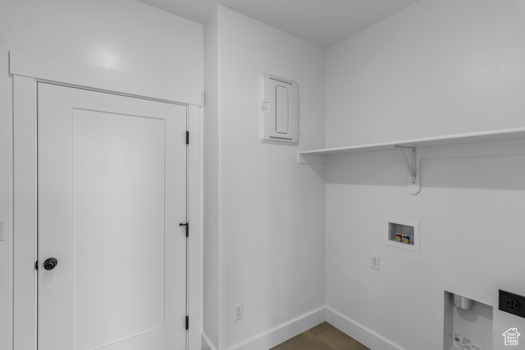 Washroom with baseboards, hookup for a washing machine, and laundry area
