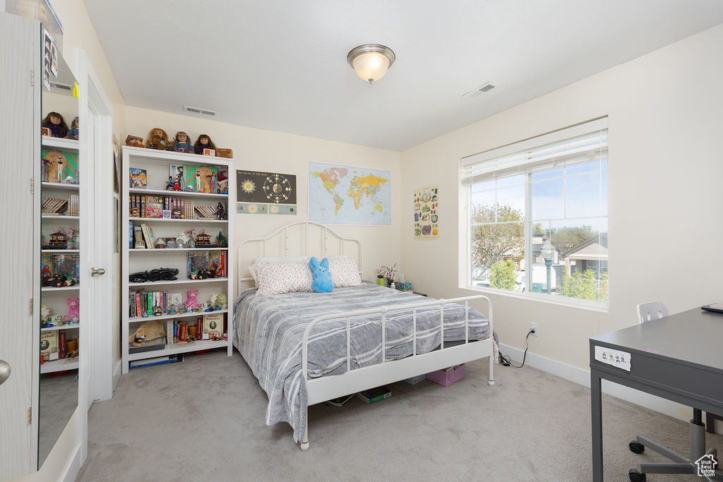Bedroom featuring visible vents, carpet, and baseboards