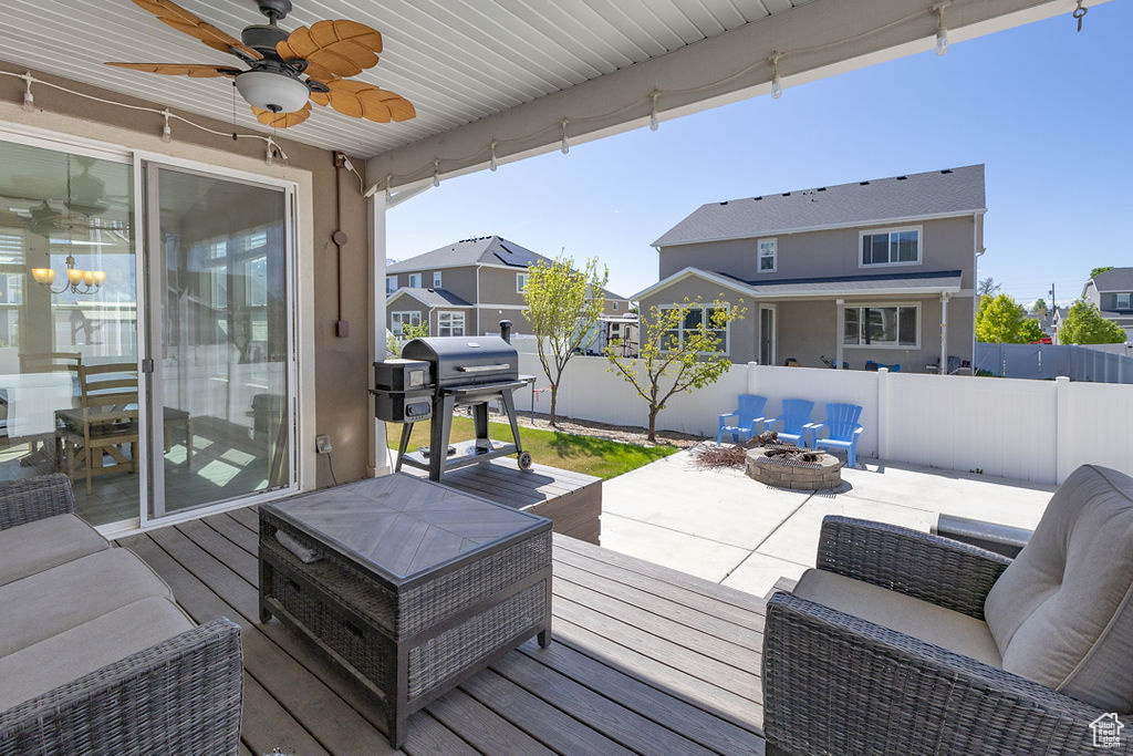 Deck featuring fence and an outdoor living space with a fire pit