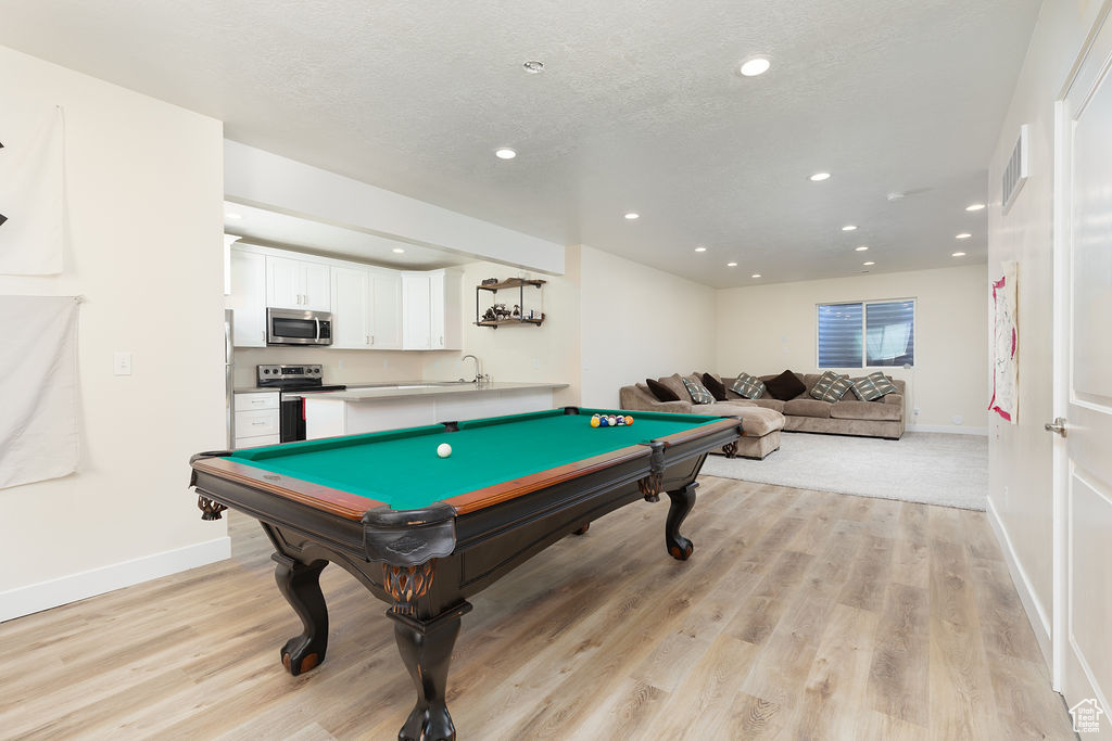Recreation room featuring baseboards, light wood-type flooring, billiards, and recessed lighting