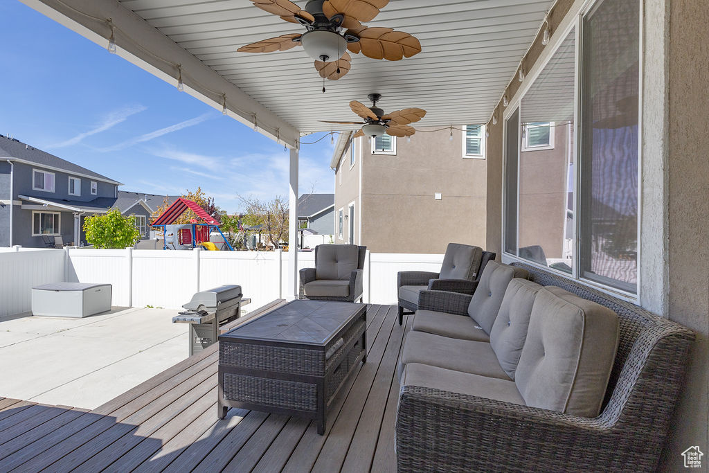 Deck featuring a patio, a residential view, outdoor lounge area, a ceiling fan, and fence