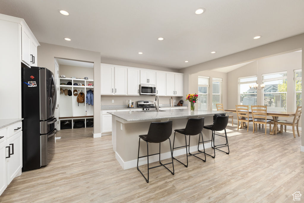 Kitchen with white cabinetry, recessed lighting, appliances with stainless steel finishes, and light wood-style floors