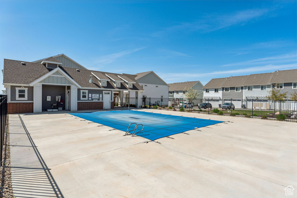 Pool with a residential view, a patio, and fence