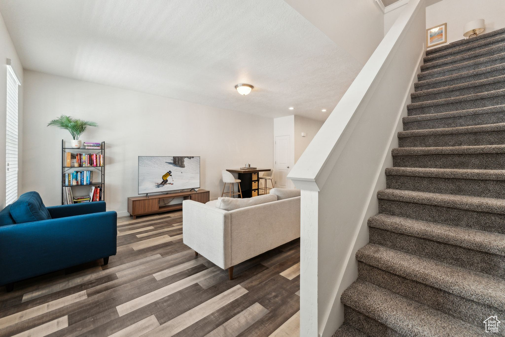 Stairs with recessed lighting and wood finished floors