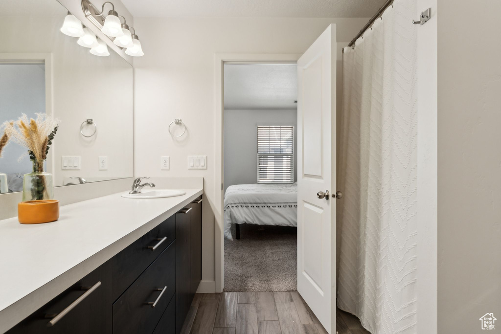 Full bathroom with wood finished floors and vanity