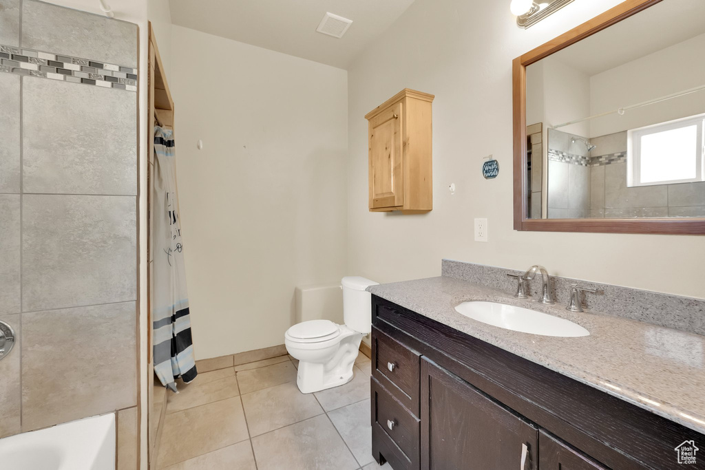 Full bathroom with vanity, toilet, and tile patterned flooring