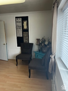 Sitting room featuring ornamental molding and light wood-style flooring