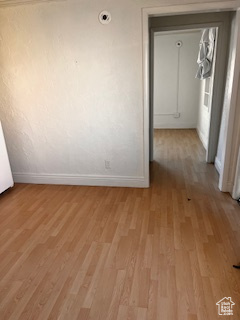 Unfurnished room featuring light wood-style flooring and baseboards