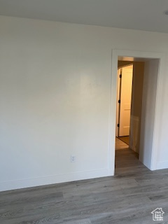 Empty room featuring wood finished floors and baseboards