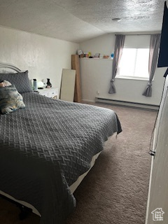 Carpeted bedroom featuring a textured ceiling, lofted ceiling, and a baseboard radiator