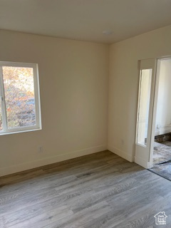 Empty room with wood finished floors and baseboards