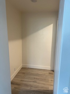 Unfurnished room featuring baseboards and wood finished floors