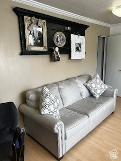 Living area featuring wood finished floors and crown molding