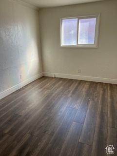Unfurnished room with dark wood-type flooring and baseboards