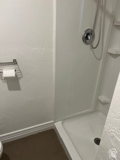 Bathroom with toilet and a stall shower