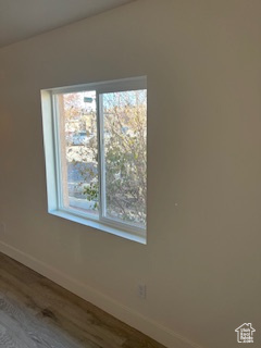 Spare room with wood finished floors and baseboards