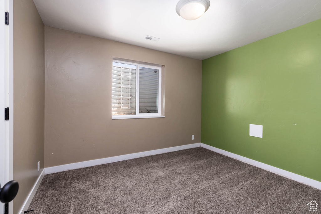 Unfurnished room featuring carpet flooring and baseboards