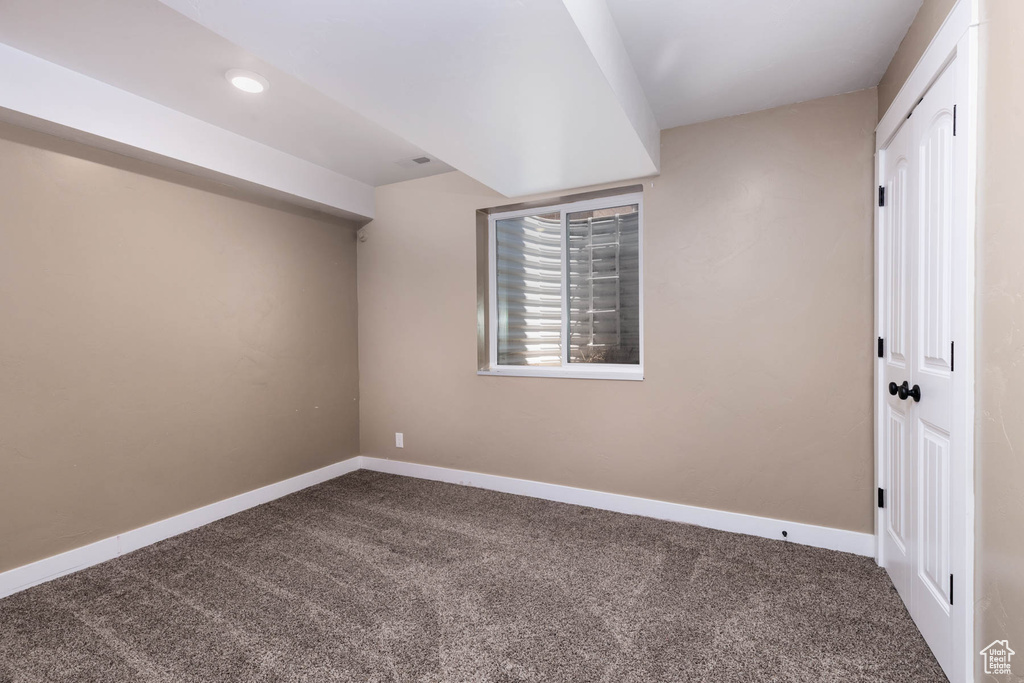 Bonus room with dark carpet, baseboards, and recessed lighting