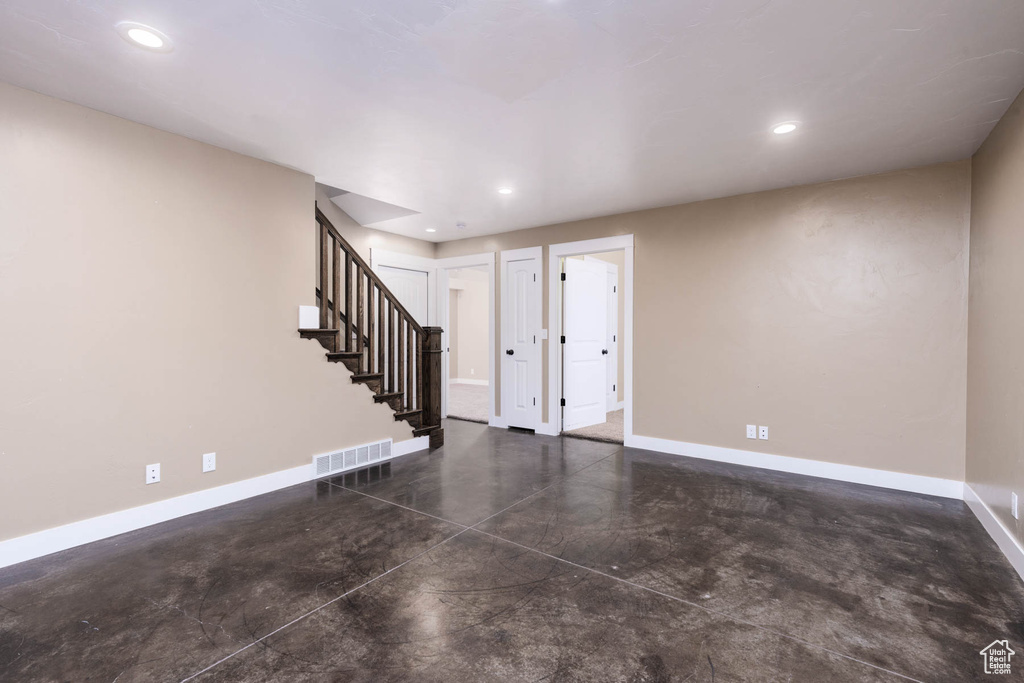 Entryway with concrete flooring, baseboards, stairway, and recessed lighting